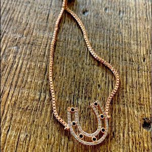 Horseshoe with sapphires bracelet in rose gold. Adjustable size.